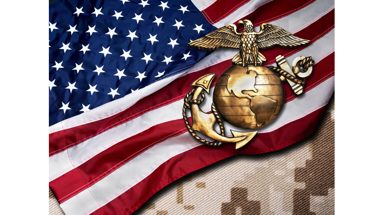 High Angle View Of Us Marine Corps On American Flag Over Table