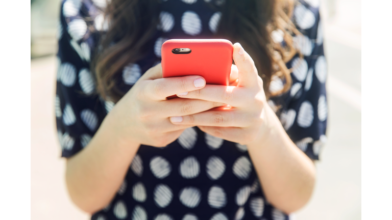Woman using a smart phone, close up.