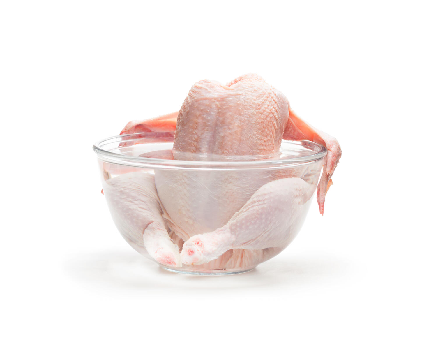 Raw  chicken in the water isolated on white background. Ready for cooking.
