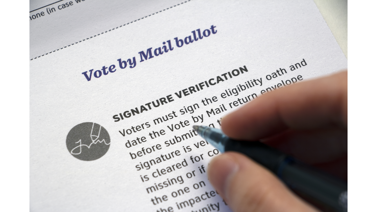 'Signature Verification' Mail Voting info and hand with pen