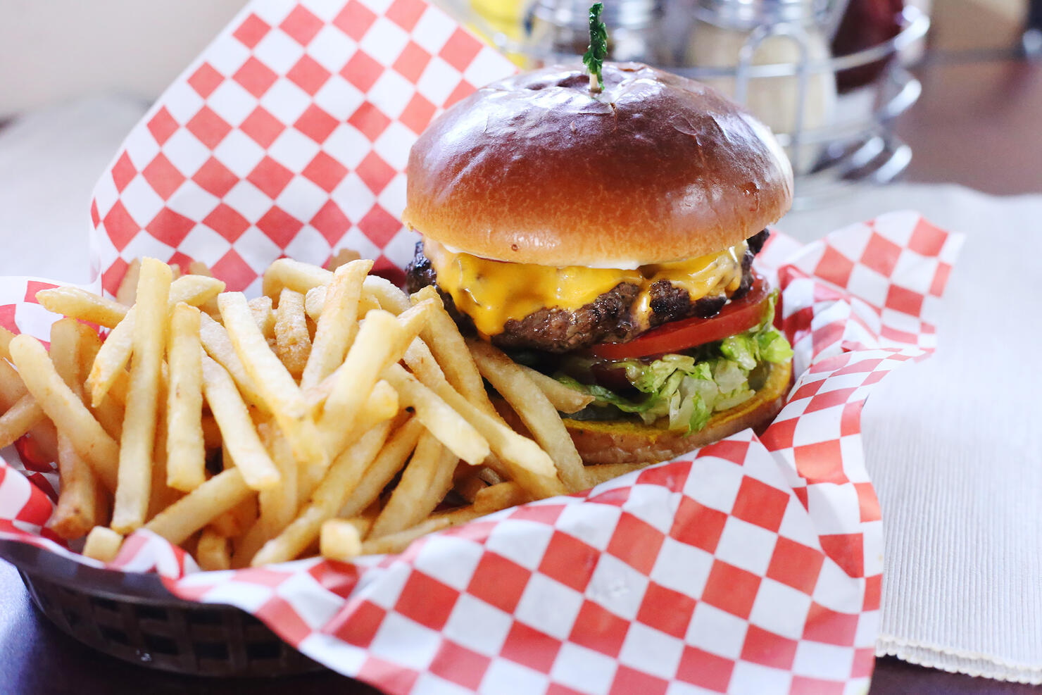 High angle view of burger with French fries served on table in restaurant