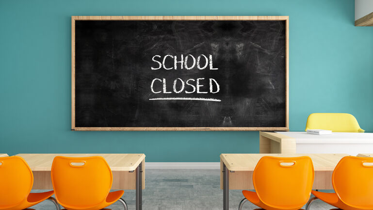 School Closed Sign on Chalkboard in Classroom