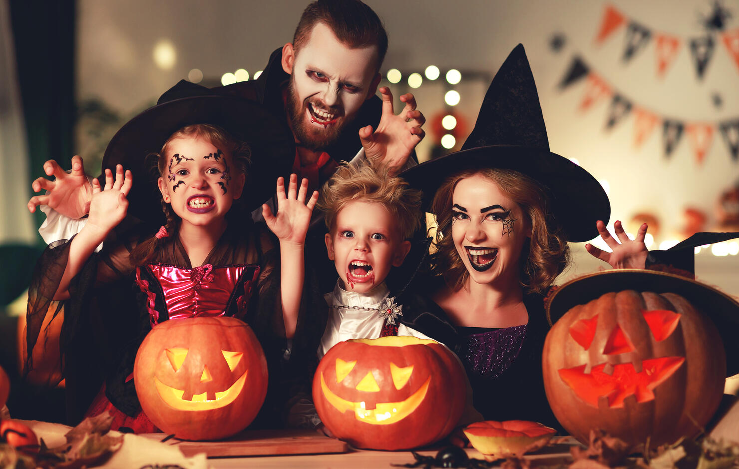 happy family mother father and children in costumes and makeup on  Halloween