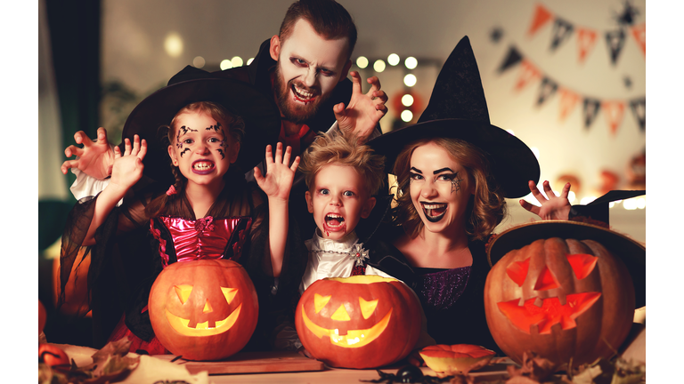happy family mother father and children in costumes and makeup on  Halloween
