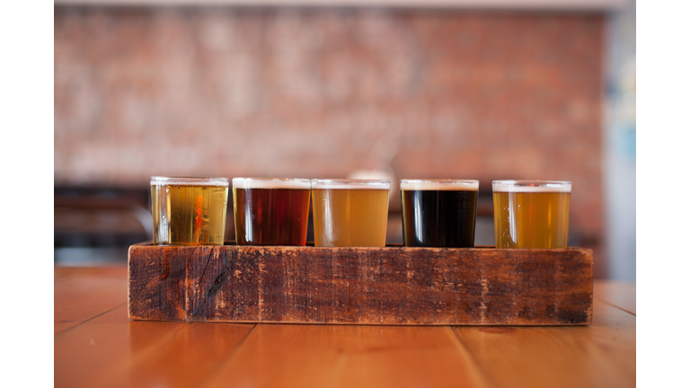 Close-Up Of Various Beer Glass In Wooden Tray On Table