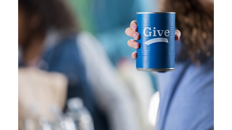 Volunteer holds donation can during food drive