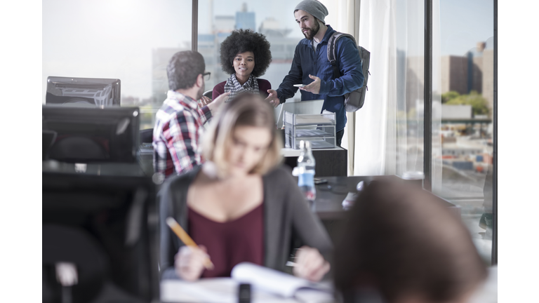Colleagues talking in office