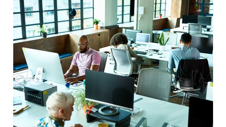 Open plan office with people working at desks