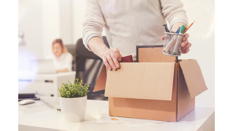 Sad dismissed worker taking his office supplies with him