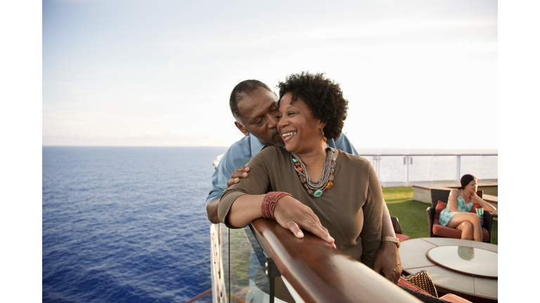 Couple on railing on deck