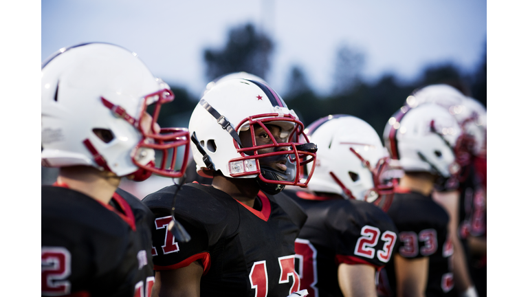 American football team with sports helmet on field