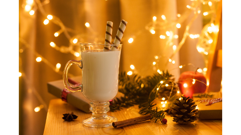 Traditional Christmas drink eggnog with candies and spices. Selective focus.