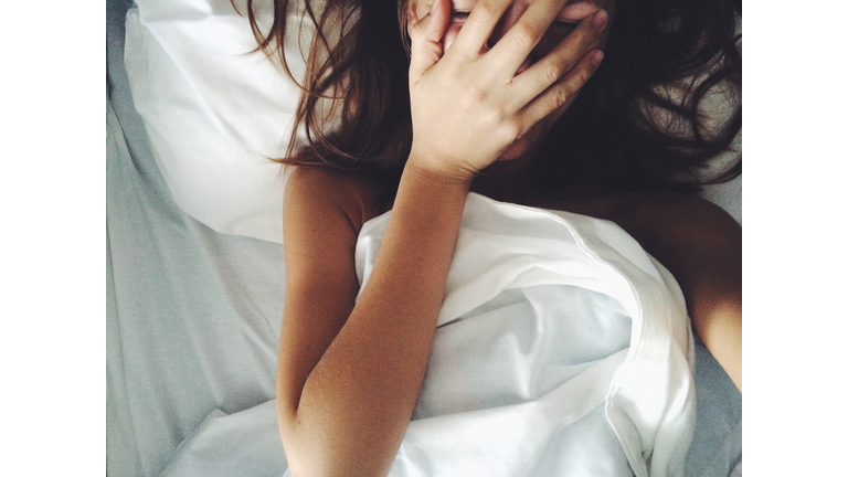 Directly Above View Of Woman Lying On Bed