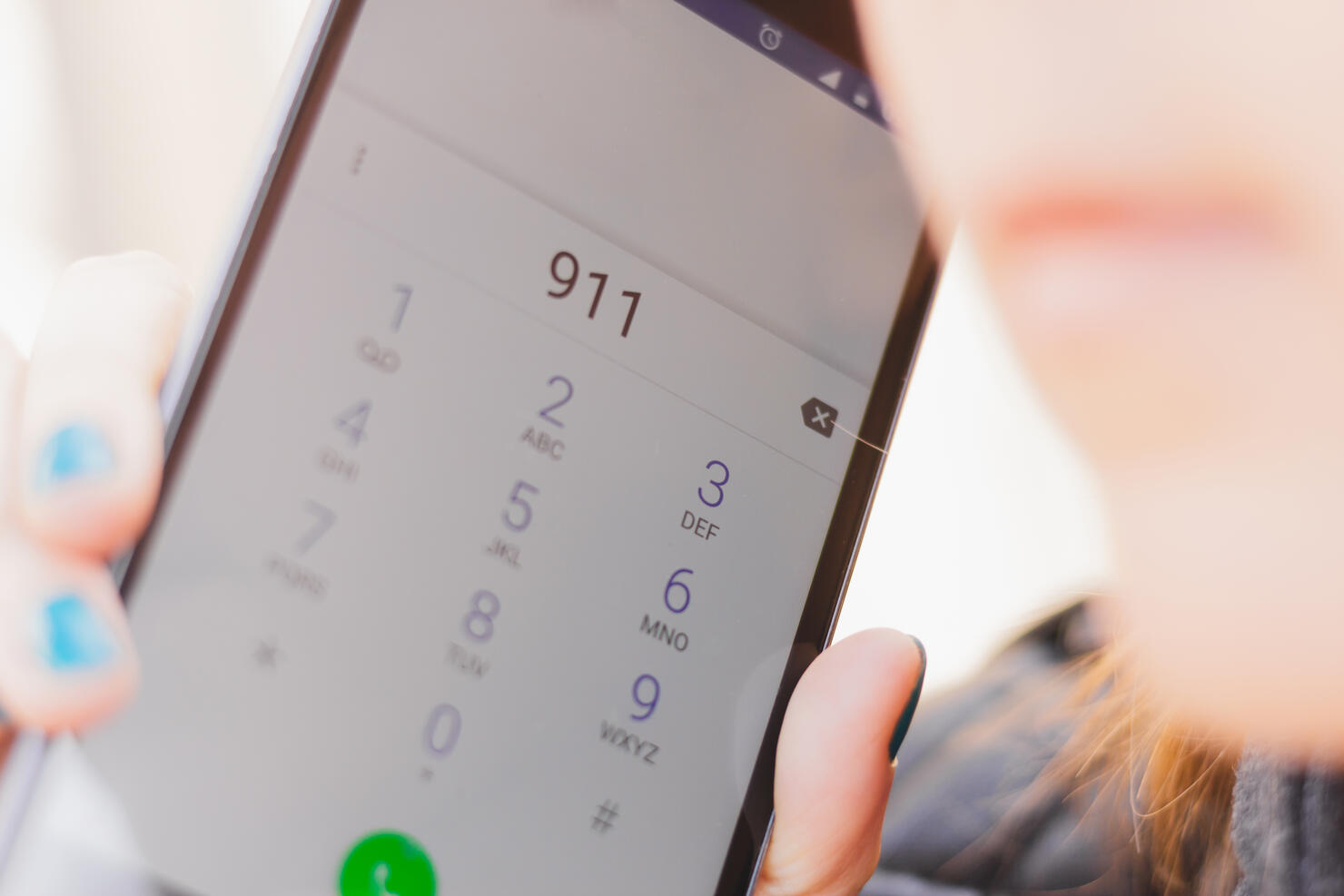 Closeup shot of phone display with the number 911 dialed