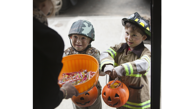 Caucasian boys trick or treating on Halloween