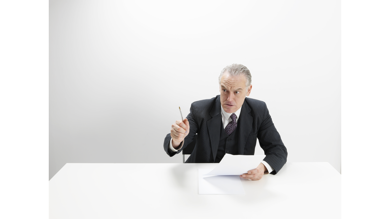 Angry businessman at desk 