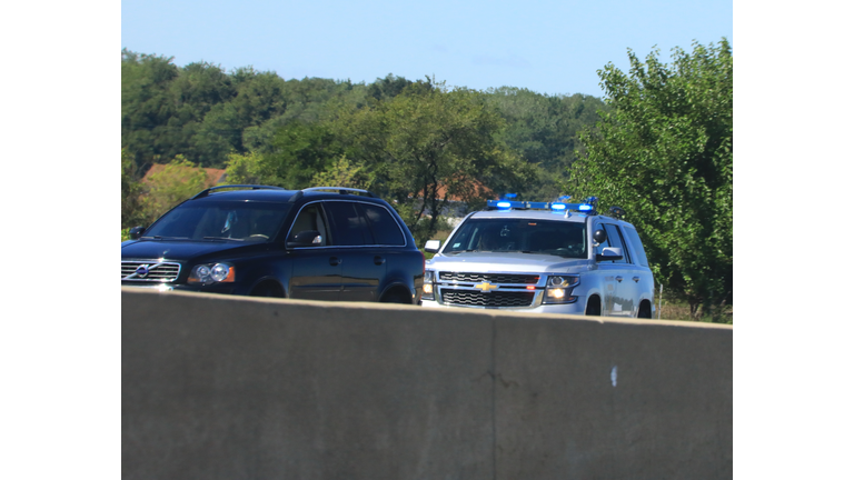 Police vehicle stops a motorist on a rural highway