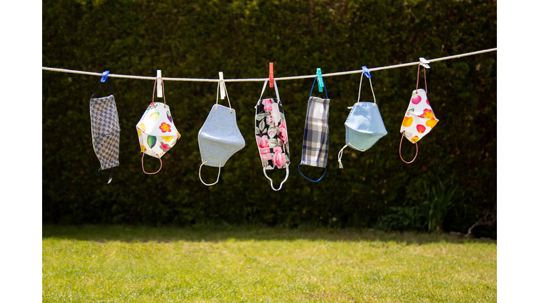 Colourful corona masks in the garden hung up on a leash