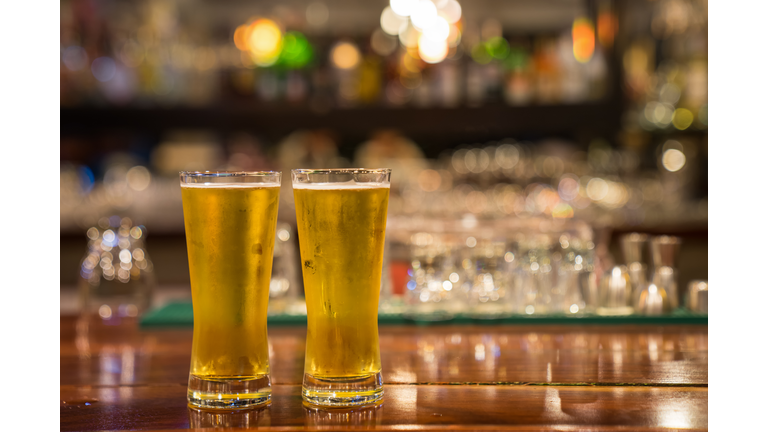 Glass of beer on the bar counter.