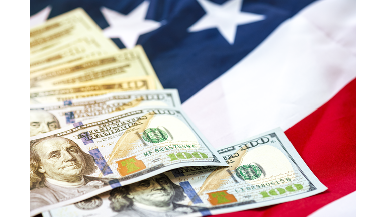 US dollar banknote on USA flag background.US dollar is main and popular currency of exchange in the world.Investment and saving concept.