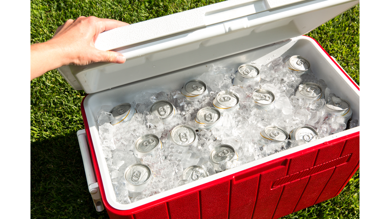 Red cooler filled with beverage cans