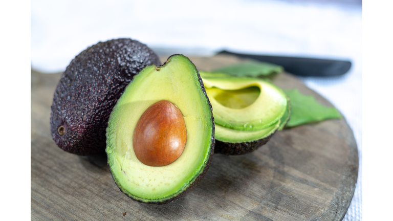 Two ripe raw hass avocados close up