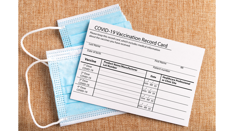 Coronavirus vaccination record card. Protective mask divided into two parts. Concept of defeating Covid-19