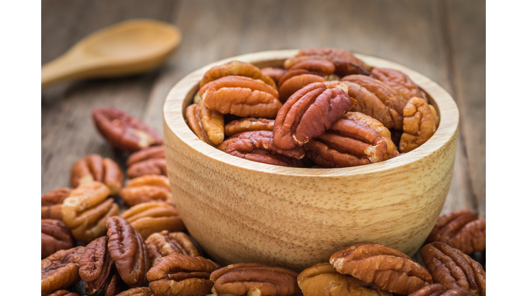 Pecan nuts in wooden bowl