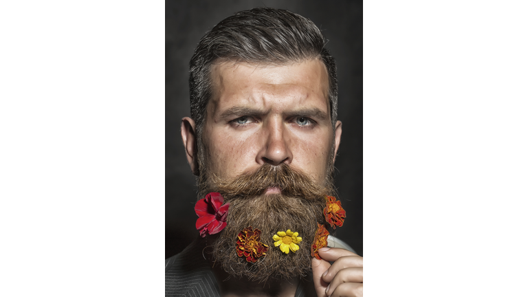 Man with flowerbed on face