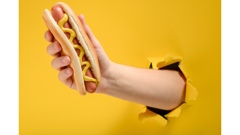Hand Taking A Hot Dog