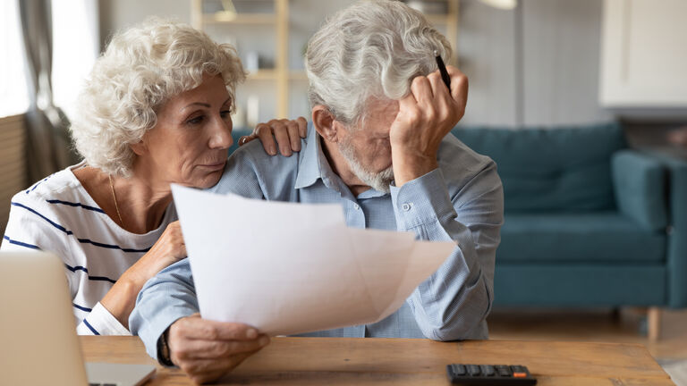 Distressed elderly couple troubles with household finances expenses