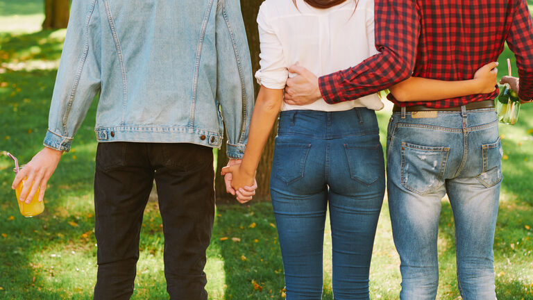 polyamorous relationship woman standing two guys