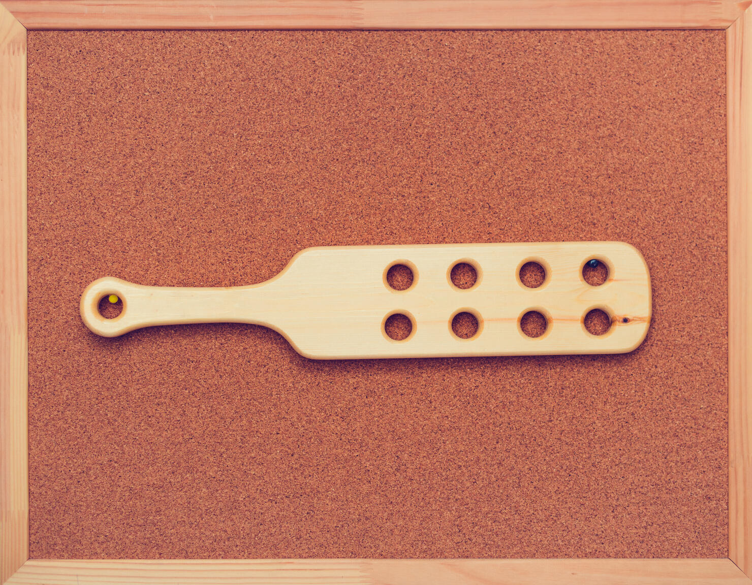 Wooden paddle for spanking on cock board on the wall. Domestic discipline. Traditional corporal punishment implements. bdsm toys, adult games, old-fashioned discipline