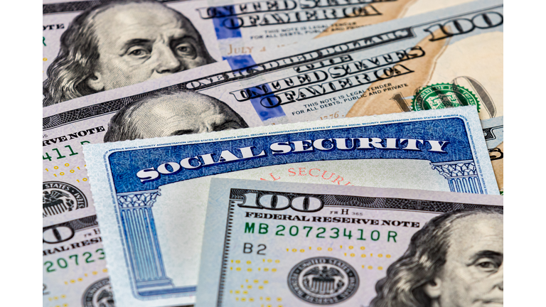 Social Security benefits identification card with 100 dollar bills