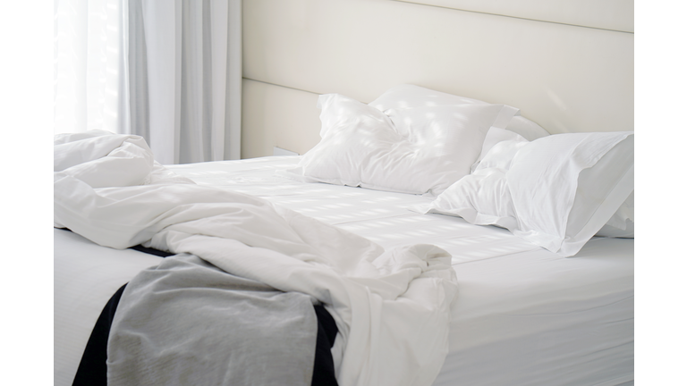 Dirty bed in the hotel. Dirty bed pillow blanket room.