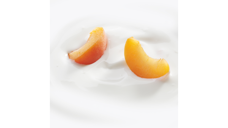 Peach slices laying in yogurt