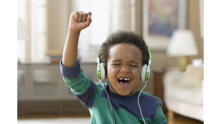 Black boy listening to music on headphones