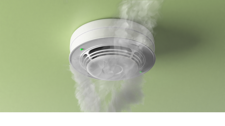 Fire detected by a smoke detector moulded on green ceiling.  Fire safety equipment. 3d illustration