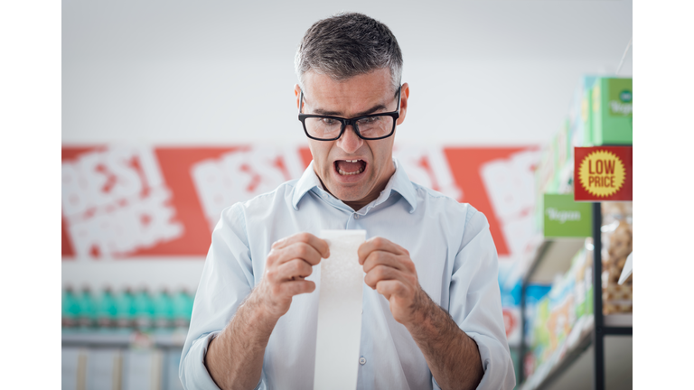 Man checking a long receipt