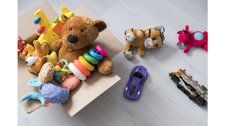 box of toys on the floor. Teddy bear in box,vintage tone. charitable contribution. donation. beneficence