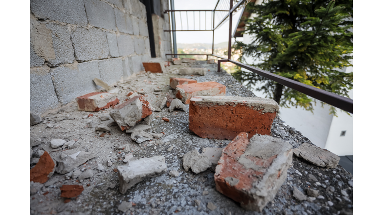 Scattered and damaged bricks on the balcony