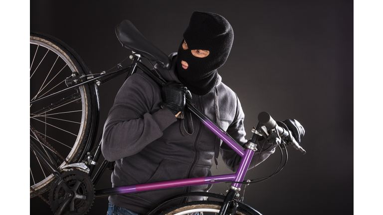 Person Wearing Balaclava Stealing A Bicycle