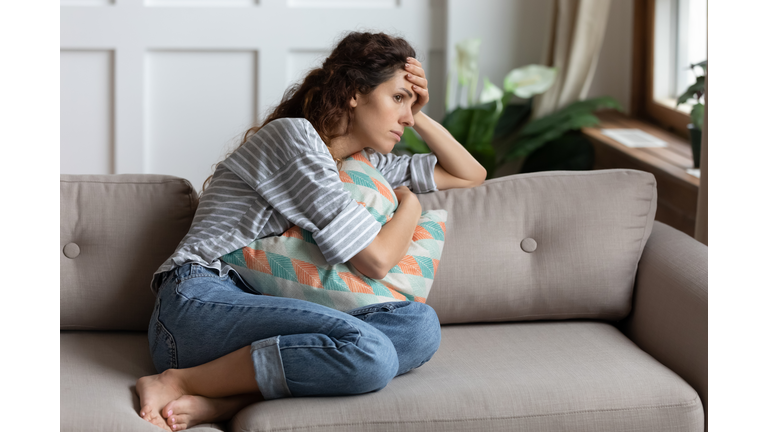 Lost in thoughts unhappy stressed woman regretting of wrong decision.