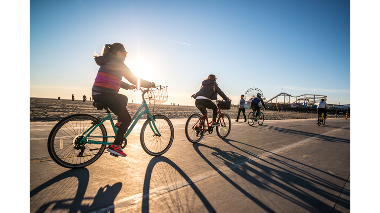 People cycling and jogging on Santa Monica beach, CA, USA