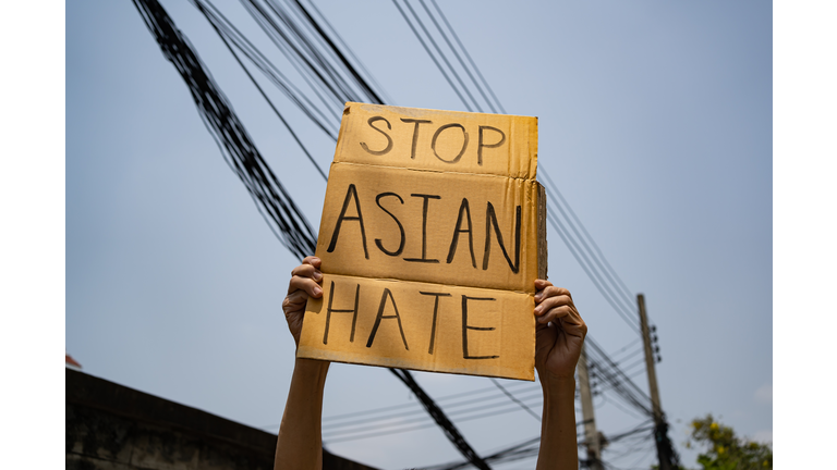 A man holding Stop Asian Hate sign