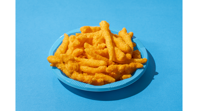 Hot Cheetos Snack On A Blue Colored Plastic Plate