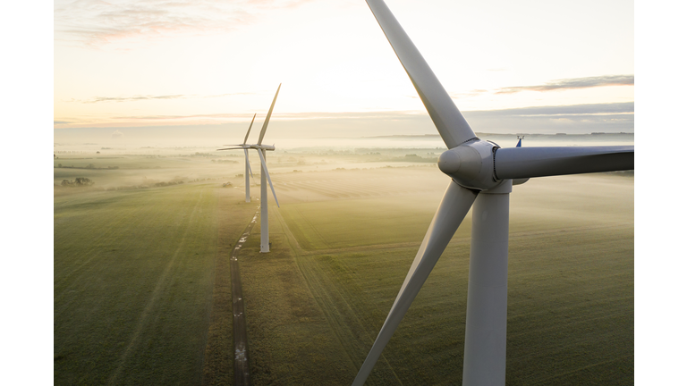 Three wind turbines at sunrise