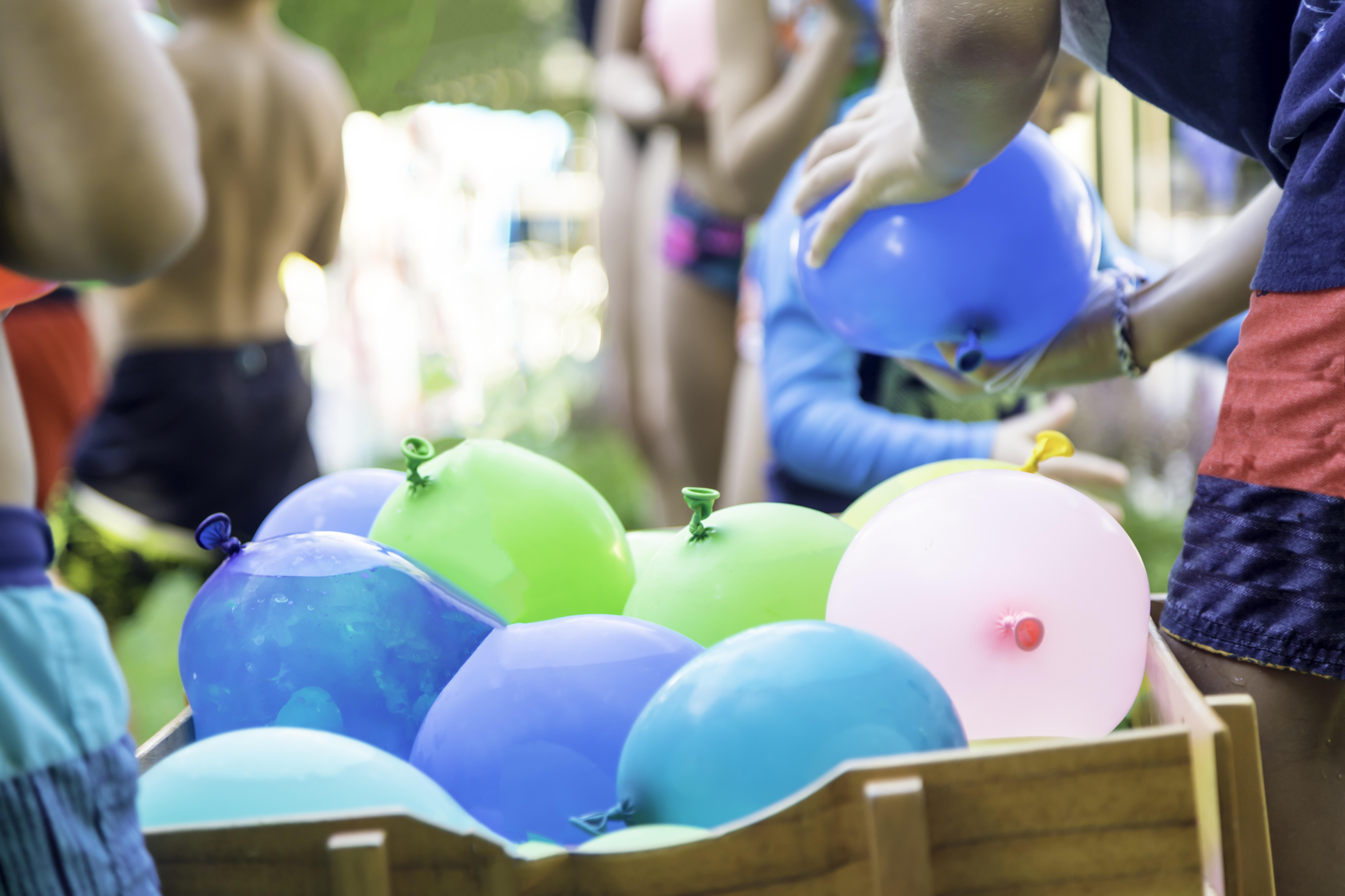 Битва шарами. Бой шариками с водой. Дети играют водными бомбочками на улице. Water Balloons Toss game.