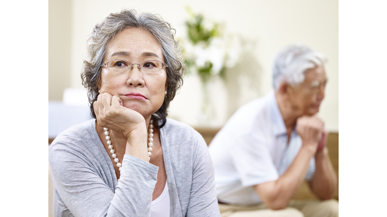 unhappy senior asian couple