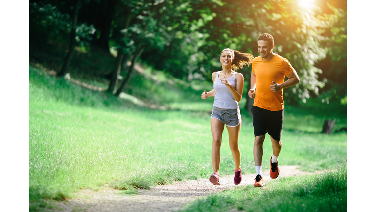 Healthy couple jogging in nature